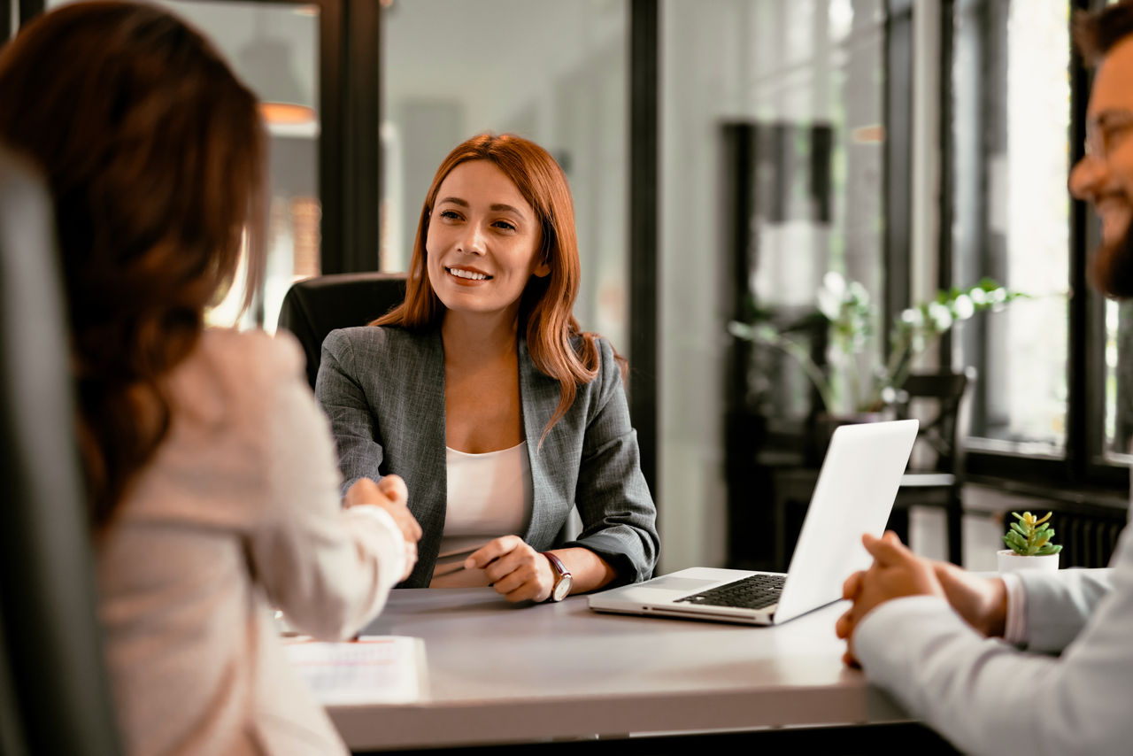 Shot of group of business persons in business meeting. Three entrepreneurs on meeting in board room. Corporate business team on meeting in modern office. Female manager discussing new project with her colleagues. Company owner on a meeting with two of her employees in her office. Three business professionals are engaged in a discussion at an office meeting, highlighting teamwork, professional attire, and a modern workplace environment.